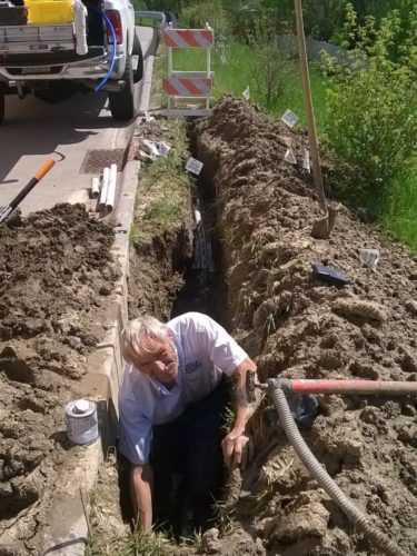 West Omaha Irrigation digging a trench for sprinkler system lines