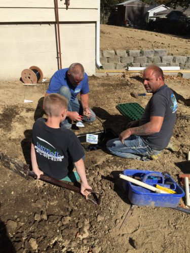 Family-owned West Omaha Irrigiation team installing a sprinkler system